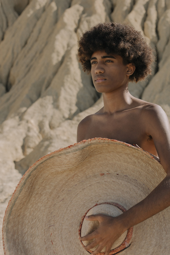 Man Holding a Brown Sun Hat