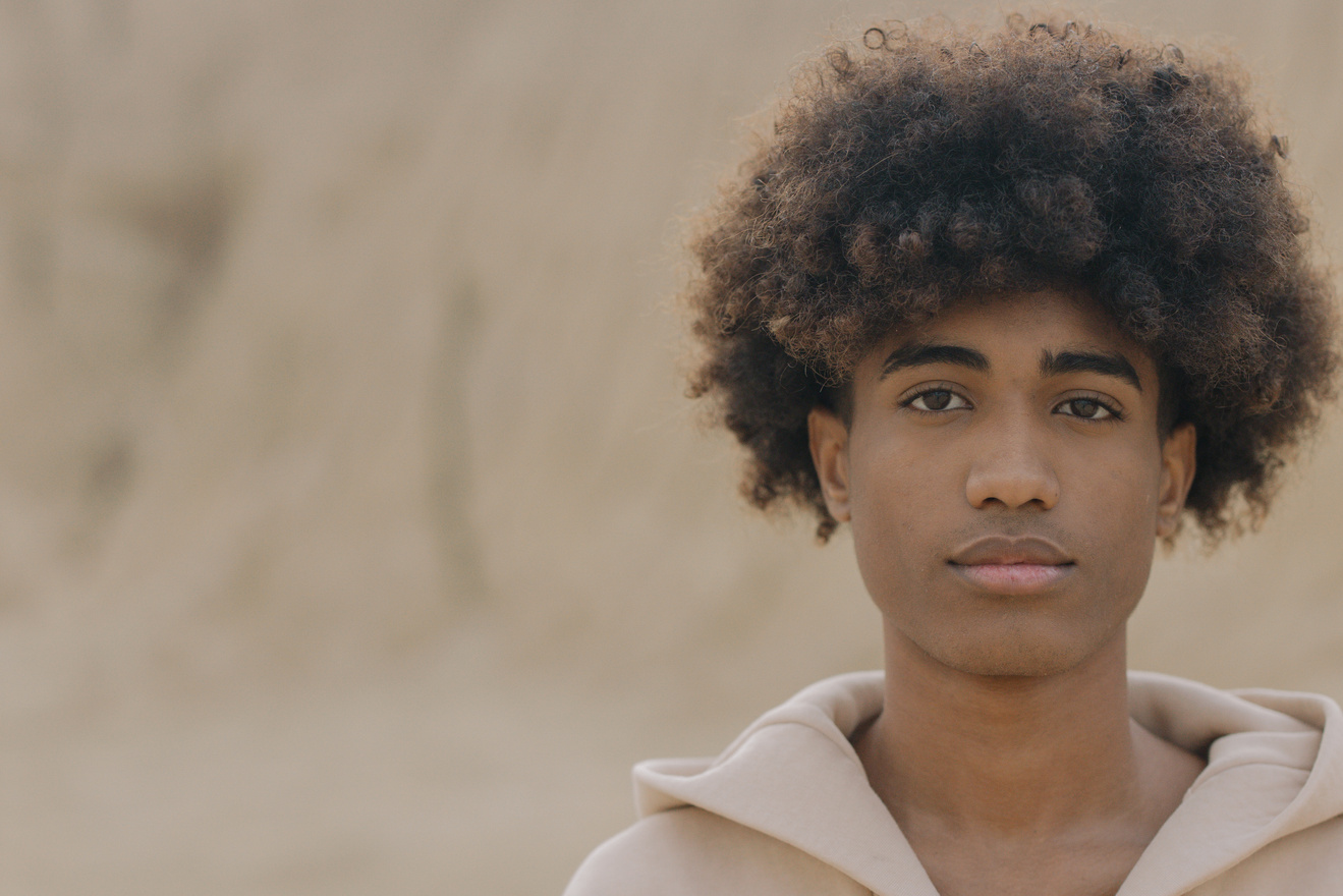 Close-up Photo of Man in Afro Hairstyle 